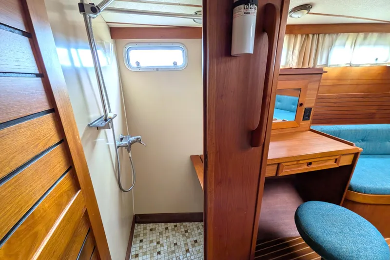 Slide: The Image of Interior of 1985 Siltala Nauticat 44 yacht featuring shower and wooden vanity area. - 62