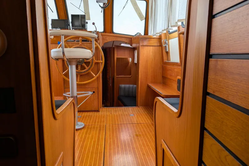 Slide: The Image of Interior of 1985 Siltala Nauticat 44 sailboat with wooden helm and seating area. - 63