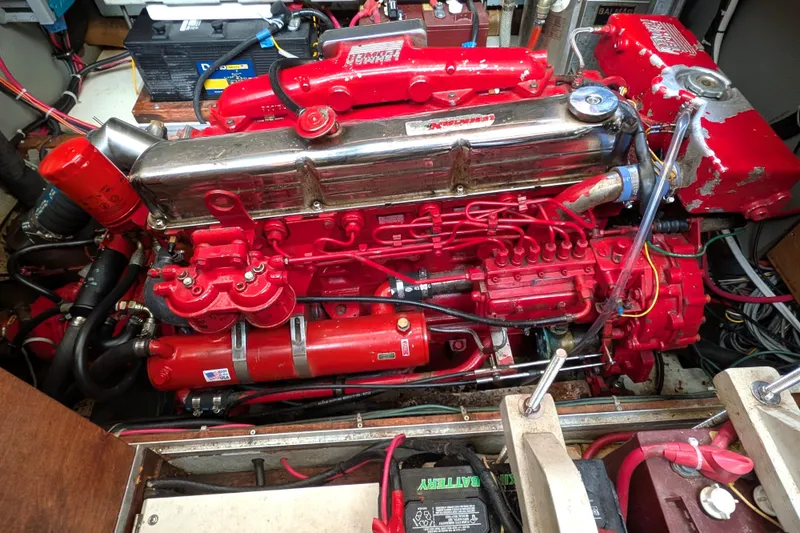 Slide: The Image of Engine compartment of a 1985 Siltala Nauticat 44, featuring a red marine engine. - 65