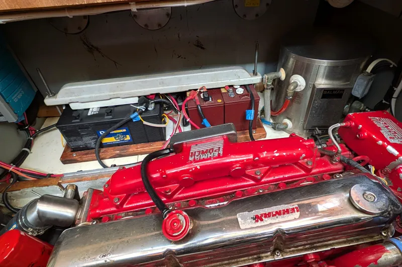 Slide: The Image of Engine room of 1985 Siltala Nauticat 44 with red engine and battery setup. - 66