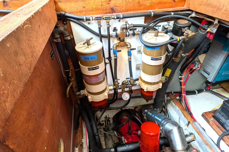 Slide: The Image of Engine room of 1985 Siltala Nauticat 44, featuring fuel filters and piping system. - 68