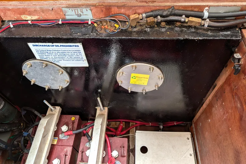 Slide: The Image of Engine compartment of a 1985 Siltala Nauticat 44 with oil discharge warning sign. - 70