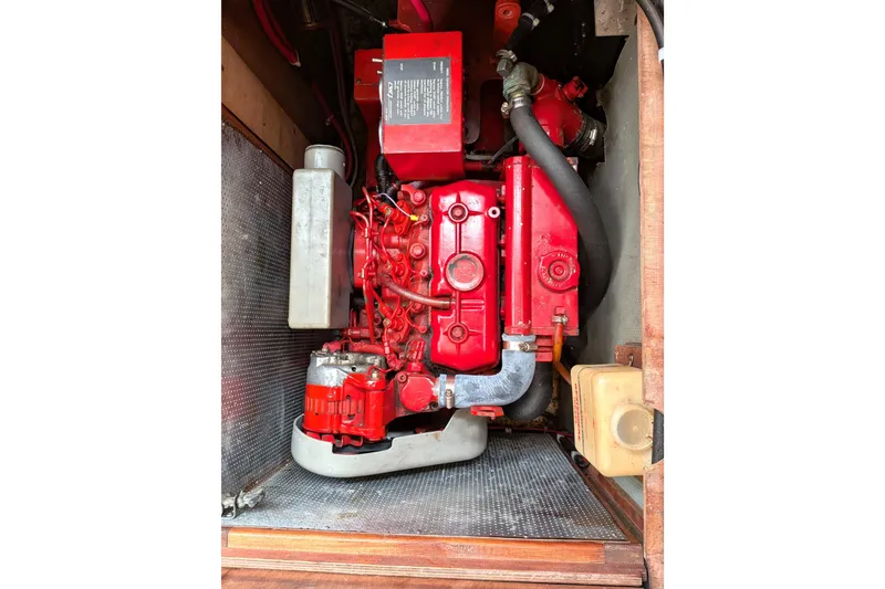 Slide: The Image of Engine compartment of a 1985 Siltala Nauticat 44, featuring a red marine engine. - 72