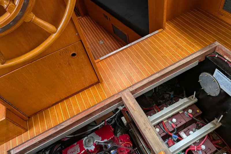 Slide: The Image of 1985 Siltala Nauticat 44 interior showing wooden helm and engine compartment. - 73