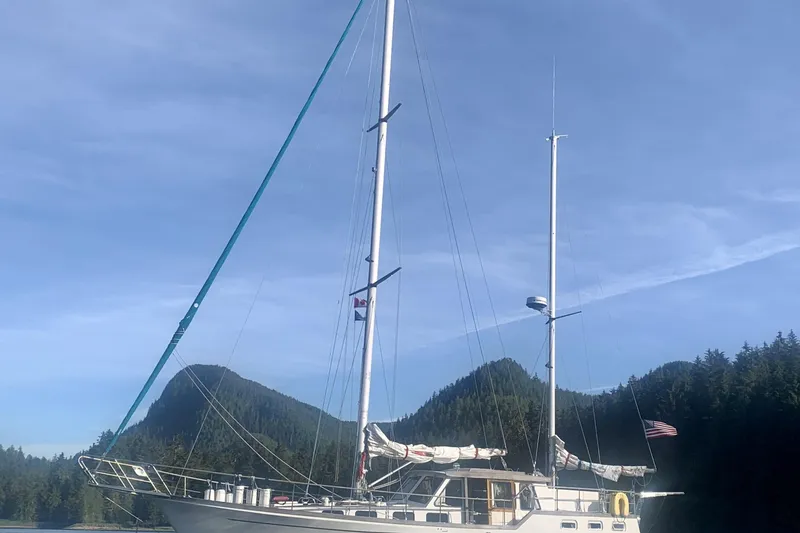 Slide: The Image of 1985 Siltala Nauticat 44 sailboat anchored in scenic mountain landscape. - 75