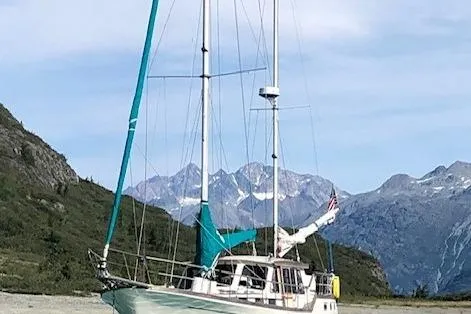 Slide: The Image of 1985 Siltala Nauticat 44 sailboat anchored with mountain backdrop. - 76