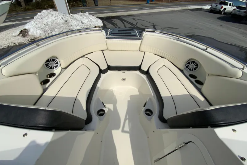 Slide: The Image of 2023 Stingray 231 DC boat interior with spacious seating and cup holders. - 19