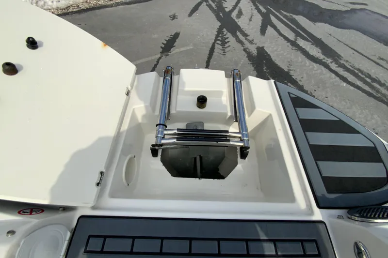 Slide: The Image of 2023 Stingray 231 DC boat with open hatch and ladder on deck. - 20