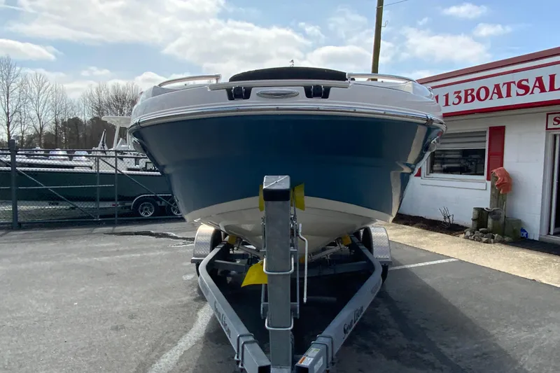 Slide: The Image of 2023 Stingray 231 DC boat on trailer at dealership, front view. - 4