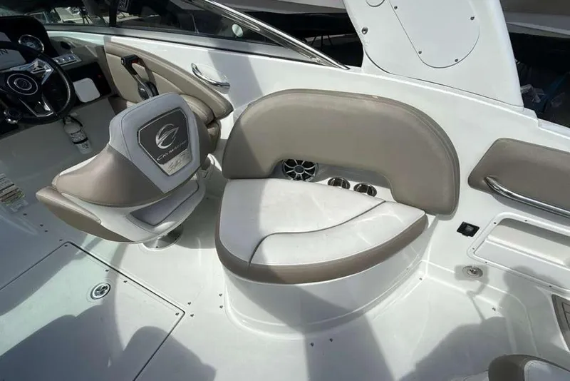 Slide: The Image of 2021 Crownline 255 XSS boat interior with beige seating and steering wheel. - 11