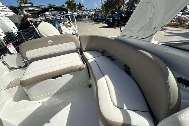 Slide: The Image of 2021 Crownline 255 XSS boat interior with beige seating and modern design. - 15