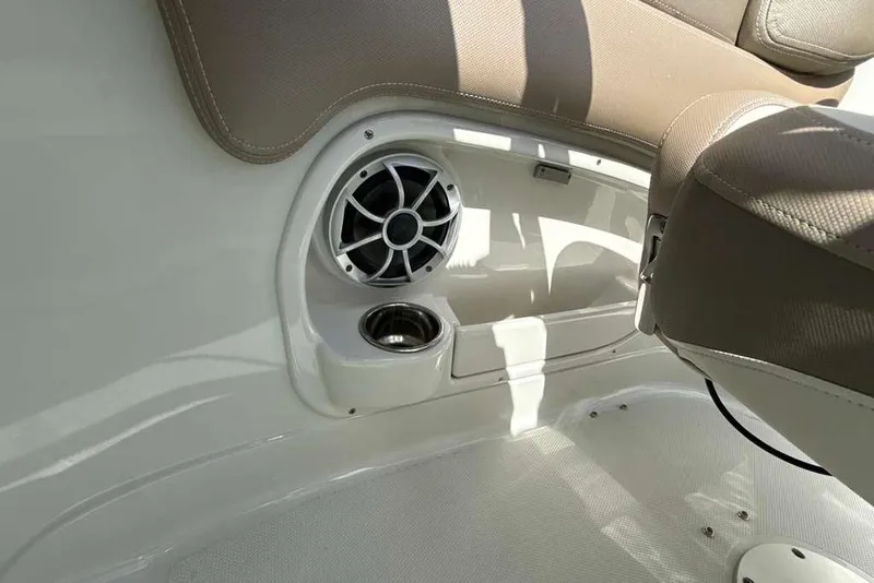 Slide: The Image of Interior of 2021 Crownline 255 XSS boat with speaker and cup holder. - 17