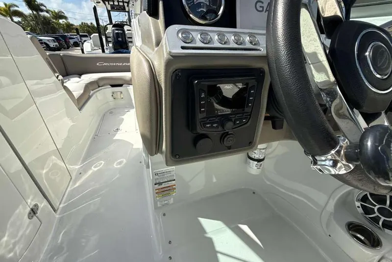 Slide: The Image of 2021 Crownline 255 XSS boat interior with steering wheel and control panel. - 19