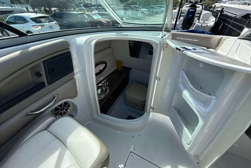 Slide: The Image of Interior view of 2021 Crownline 255 XSS boat, featuring cabin entrance and seating area. - 21