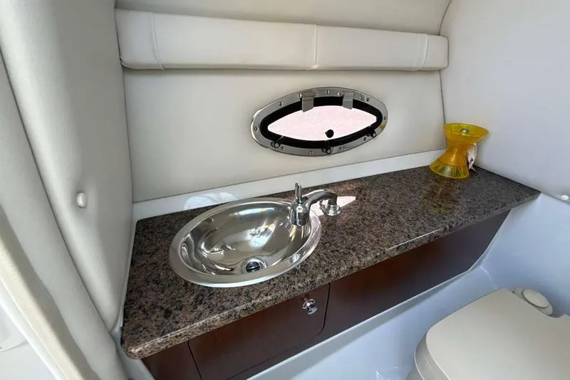 Slide: The Image of 2021 Crownline 255 XSS boat interior with sink and granite countertop. - 23