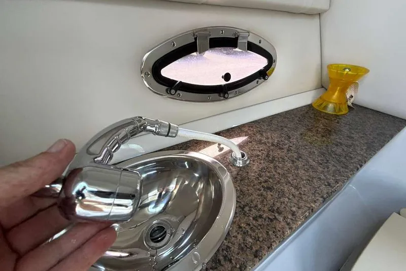 Slide: The Image of Interior of 2021 Crownline 255 XSS boat with sink and countertop. - 24