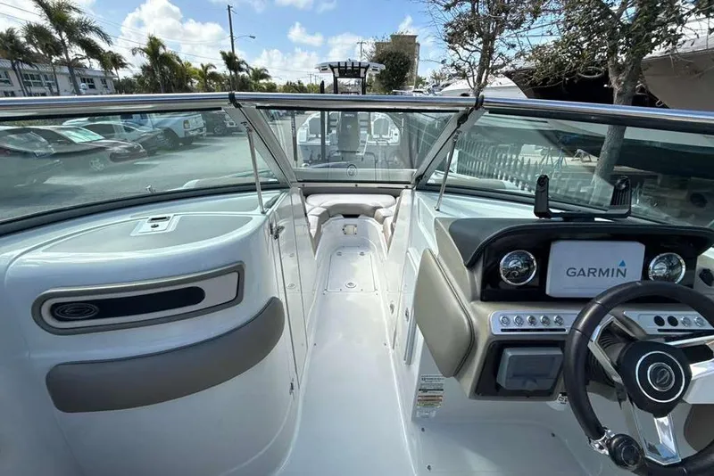 Slide: The Image of 2021 Crownline 255 XSS boat interior with Garmin navigation system, sleek design, and comfortable seating. - 25