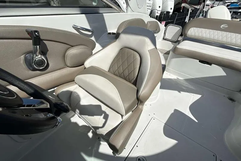 Slide: The Image of 2021 Crownline 255 XSS boat interior with beige and white seating. - 30