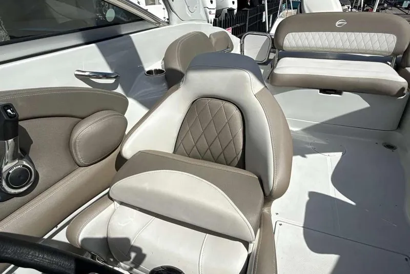 Slide: The Image of 2021 Crownline 255 XSS boat interior with beige and white seating. - 31