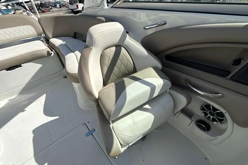 Slide: The Image of 2021 Crownline 255 XSS boat interior with beige seating and speaker system. - 33