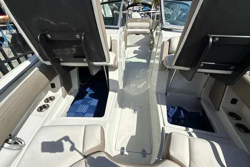 Slide: The Image of 2021 Crownline 255 XSS boat interior with seating and storage compartments. - 37