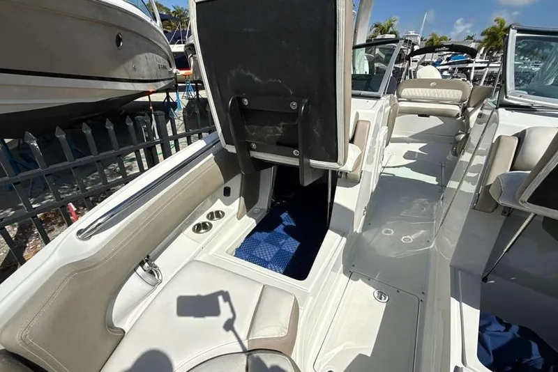 Slide: The Image of 2021 Crownline 255 XSS boat interior with seating and storage compartments. - 38