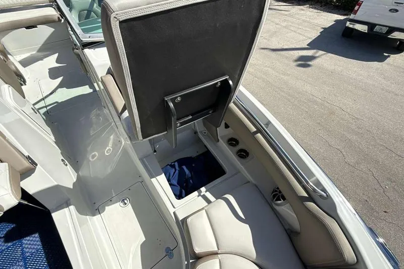 Slide: The Image of 2021 Crownline 255 XSS boat interior with open storage compartment and seating. - 39