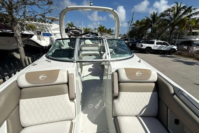 Slide: The Image of 2021 Crownline 255 XSS boat interior with beige seating and open deck. - 40
