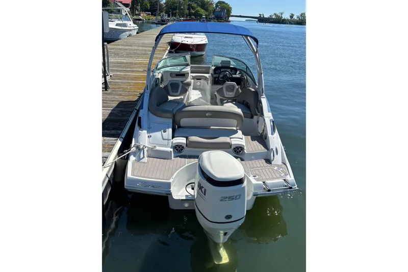 Slide: The Image of 2021 Crownline 255 XSS boat docked, featuring a sleek design and powerful outboard motor. - 45