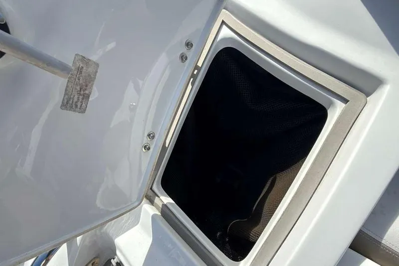 Slide: The Image of Open storage compartment on a 2021 Crownline 255 XSS boat. - 7