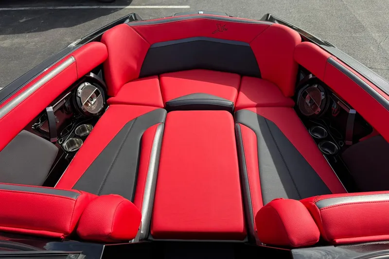 Slide: The Image of Red and black interior of 2020 MasterCraft XStar boat with premium seating and speakers. - 13