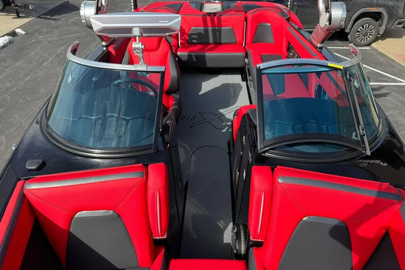 Slide: The Image of 2020 MasterCraft XStar boat interior with red and black seating, showcasing luxury design. - 14