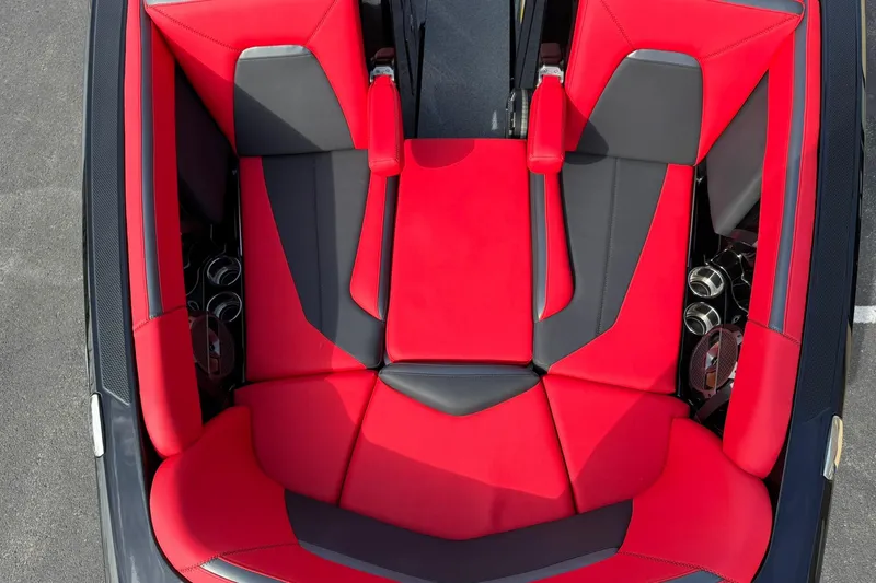 Slide: The Image of Red and black interior of 2020 MasterCraft XStar boat, featuring stylish seating and cup holders. - 15