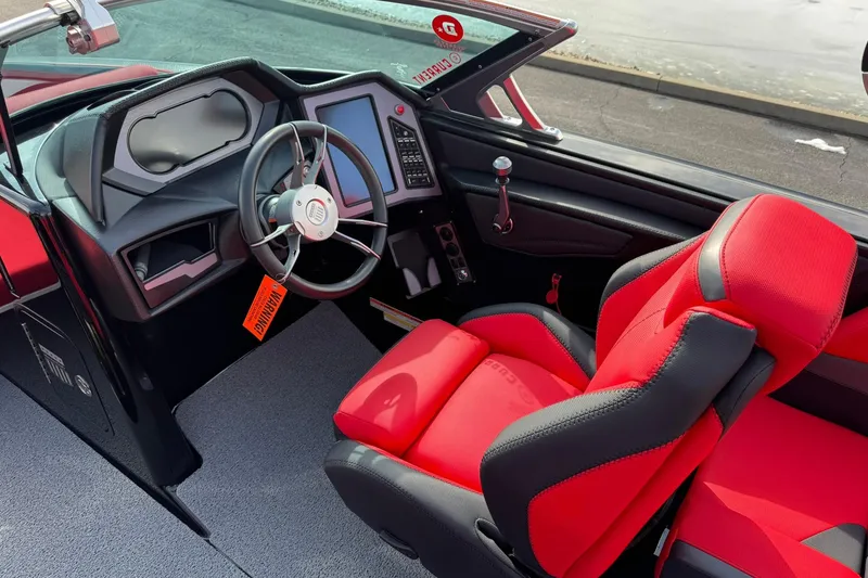 Slide: The Image of 2020 MasterCraft XStar interior with red and black seating, modern dashboard, and steering wheel. - 17