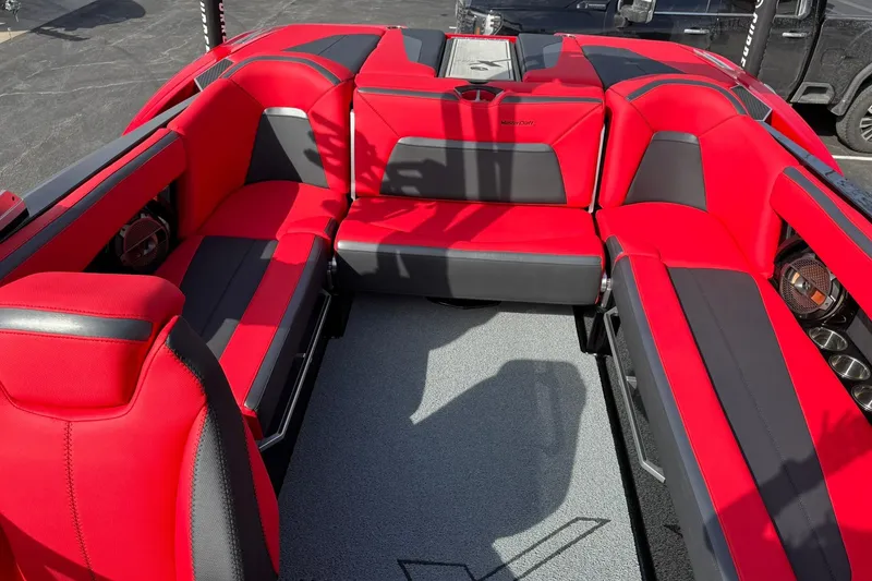 Slide: The Image of 2020 MasterCraft XStar boat interior with red and black seating, showcasing luxury design. - 19