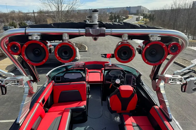Slide: The Image of 2020 MasterCraft XStar boat with red and black interior, featuring multiple overhead speakers. - 21