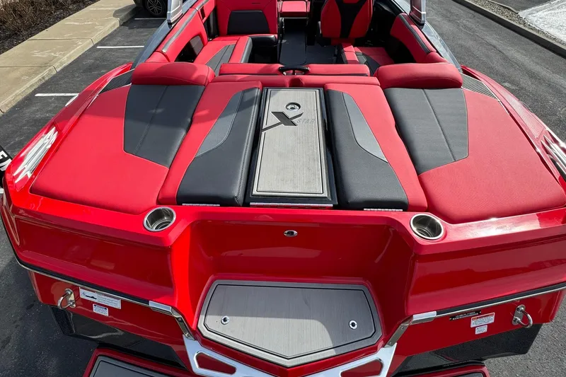 Slide: The Image of 2020 MasterCraft XStar boat with red and black seating, rear view. - 26