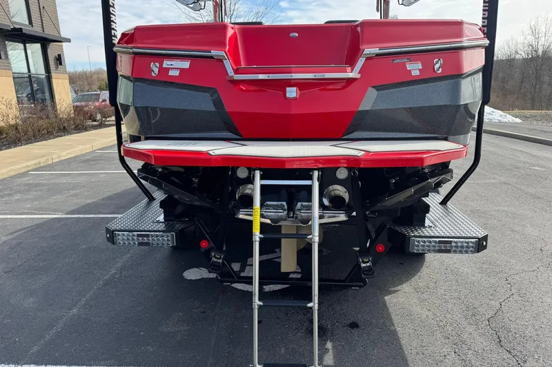 Slide: The Image of Rear view of a 2020 MasterCraft XStar boat in a parking lot. - 27