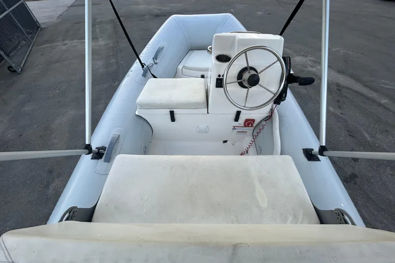 Slide: The Image of 2021 AB Inflatables Mares 10 VSX boat interior with steering wheel and seating. - 13