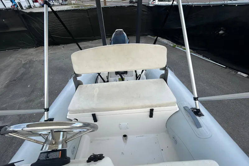 Slide: The Image of 2021 AB Inflatables Mares 10 VSX boat interior with steering wheel and seating. - 19