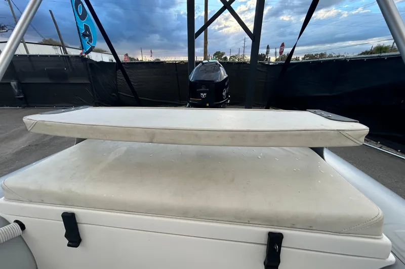 Slide: The Image of 2021 AB Inflatables Mares 10 VSX boat with cushioned seating and outboard motor. - 22