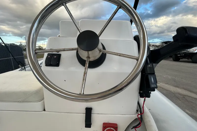 Slide: The Image of 2021 AB Inflatables Mares 10 VSX steering wheel and control panel under cloudy sky. - 26