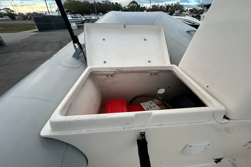 Slide: The Image of 2021 AB Inflatables Mares 10 VSX storage compartment with open lid, showing interior details. - 30