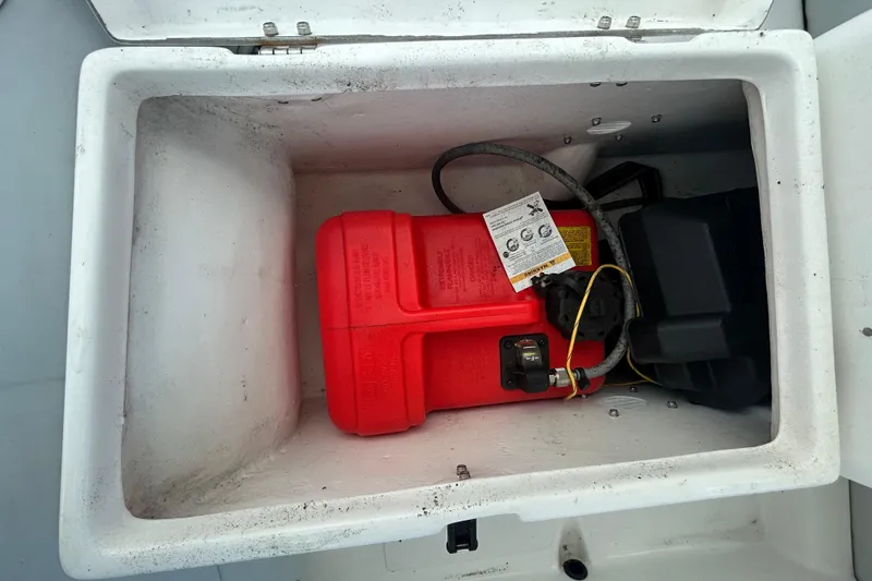 Slide: The Image of Storage compartment of 2021 AB Inflatables Mares 10 VSX with red fuel tank. - 31