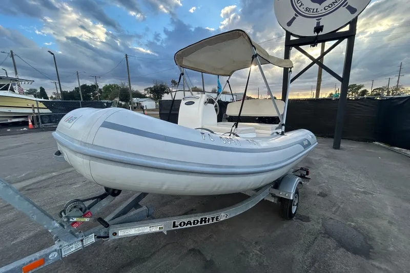 Slide: The Image of 2021 AB Inflatables Mares 10 VSX boat on trailer, under cloudy sky. - 9