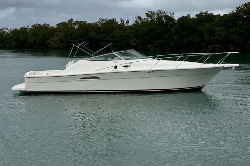 The Image of Riviera 3000 Offshore 2000 on calm water with trees in background. - 0