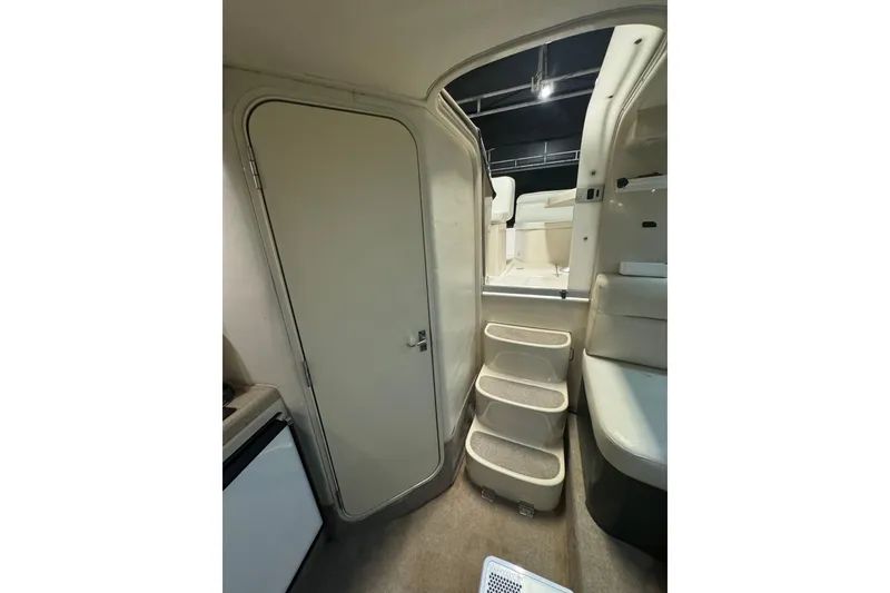Slide: The Image of Interior view of 2000 Riviera 3000 Offshore boat, featuring stairs and cabin door. - 10