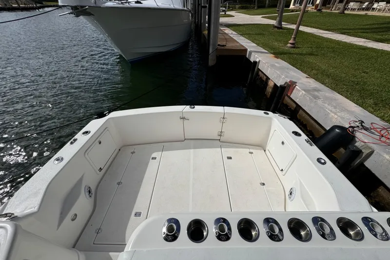 Slide: The Image of Riviera 3000 Offshore 2000 model boat docked, spacious deck, sunny day. - 16