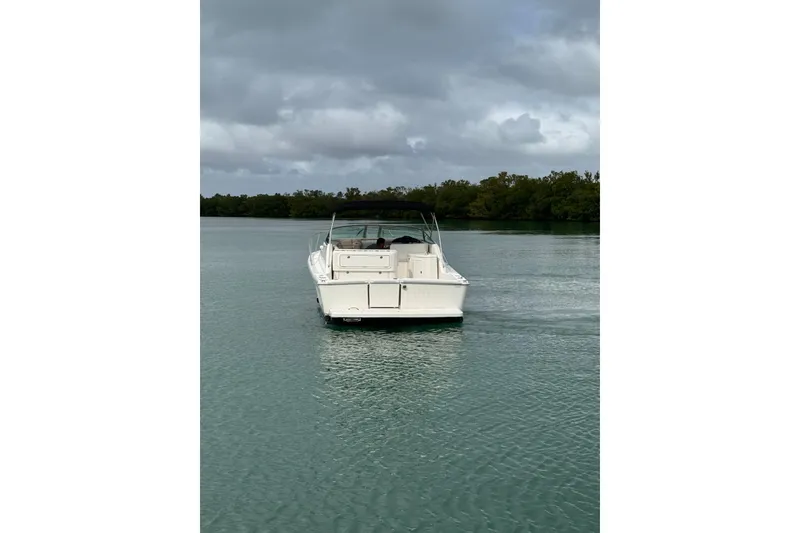Slide: The Image of Riviera 3000 Offshore 2000 model boat on calm water under cloudy sky. - 19