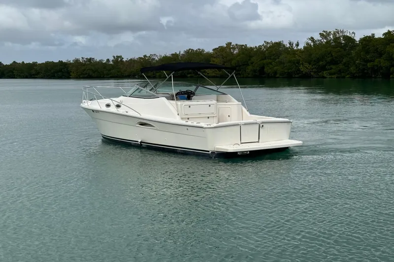 Slide: The Image of Riviera 3000 Offshore 2000 model boat on calm water, overcast sky. - 2